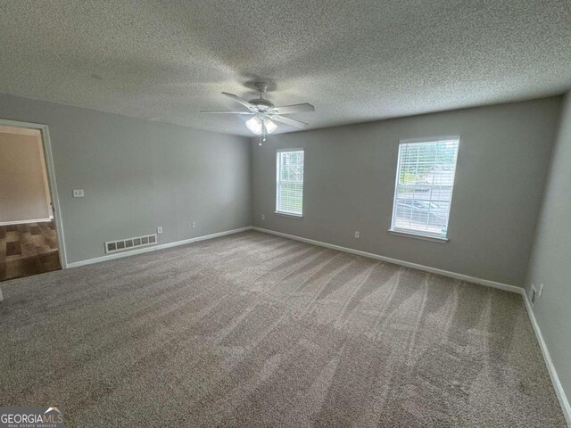 4911 Hairston Pl, Stone Mountain, GA 30088 - carpeted empty room with a ceiling fan and a textured ceiling