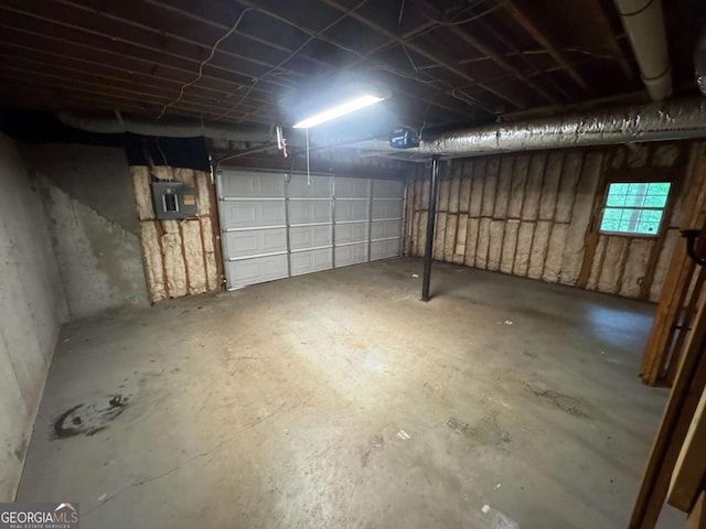 garage featuring electric panel and a garage door opener