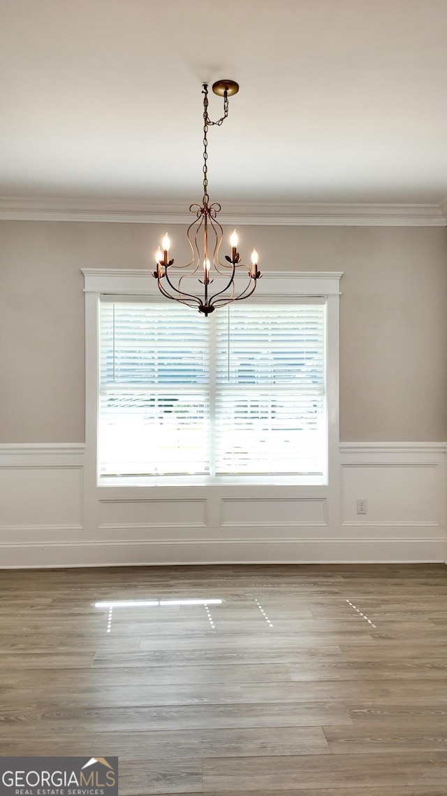 216 Morningside Dr, Thomasville, GA 31792 - unfurnished dining area featuring wainscoting, an inviting chandelier, crown molding, and a healthy amount of sunlight