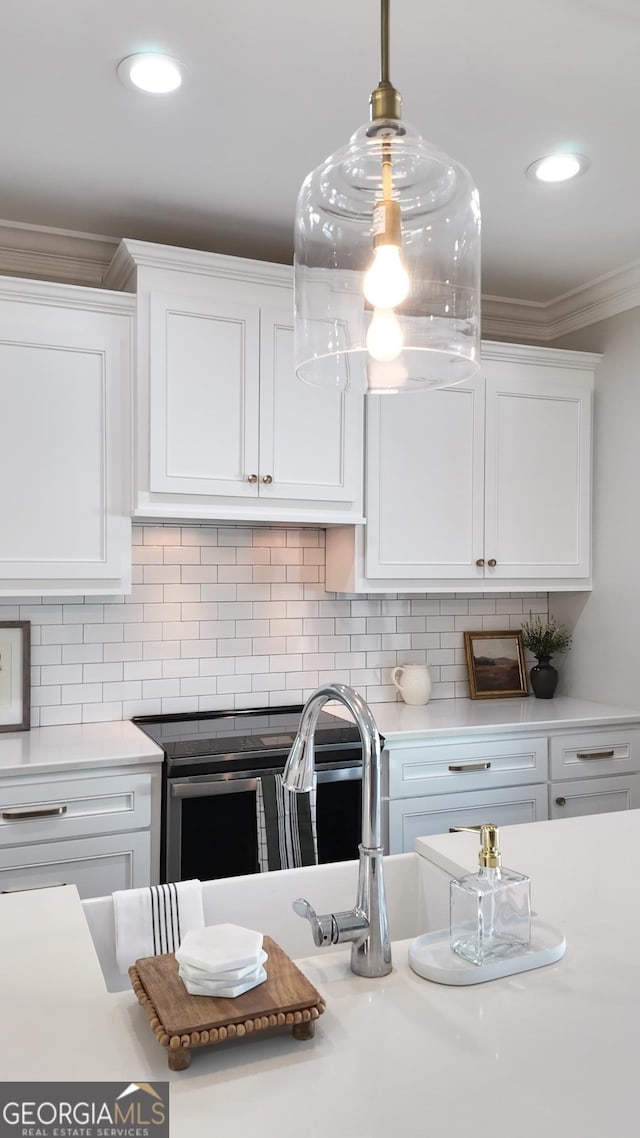 216 Morningside Dr, Thomasville, GA 31792 - kitchen with recessed lighting, ornamental molding, decorative backsplash, light countertops, and white cabinets