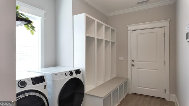 216 Morningside Dr, Thomasville, GA 31792 - laundry area with laundry area, visible vents, crown molding, light wood-style flooring, and separate washer and dryer