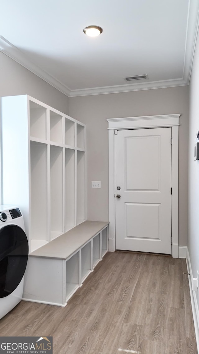 216 Morningside Dr, Thomasville, GA 31792 - mudroom featuring washer / clothes dryer, ornamental molding, visible vents, light wood-style flooring, and baseboards