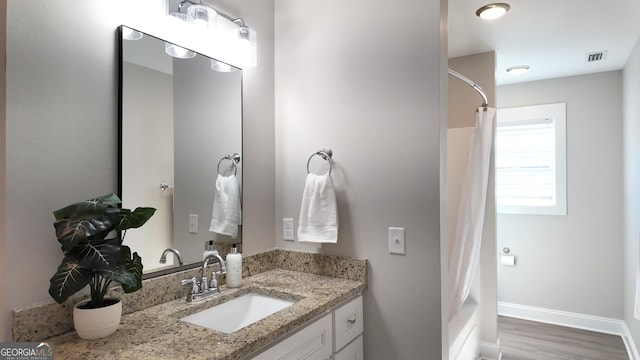 216 Morningside Dr, Thomasville, GA 31792 - full bathroom featuring vanity, a shower with shower curtain, visible vents, and wood finished floors
