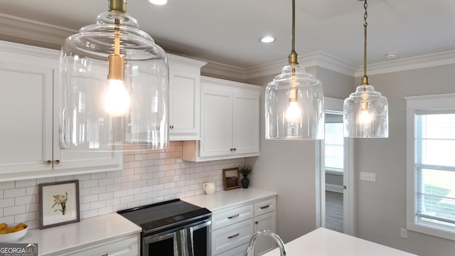216 Morningside Dr, Thomasville, GA 31792 - kitchen featuring white cabinetry, a healthy amount of sunlight, light countertops, and range with electric stovetop