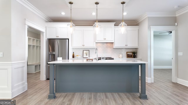 216 Morningside Dr, Thomasville, GA 31792 - kitchen featuring white cabinets, light countertops, tasteful backsplash, and stainless steel refrigerator with ice dispenser