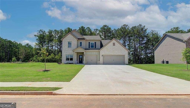 view of front facade with a front yard, an attached garage, driveway, and stone siding