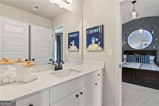bathroom featuring baseboards, vanity, and visible vents