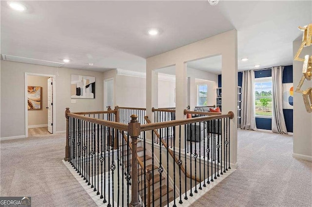 hallway with carpet, an upstairs landing, baseboards, and recessed lighting