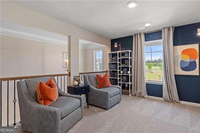 living area featuring crown molding, carpet floors, and baseboards
