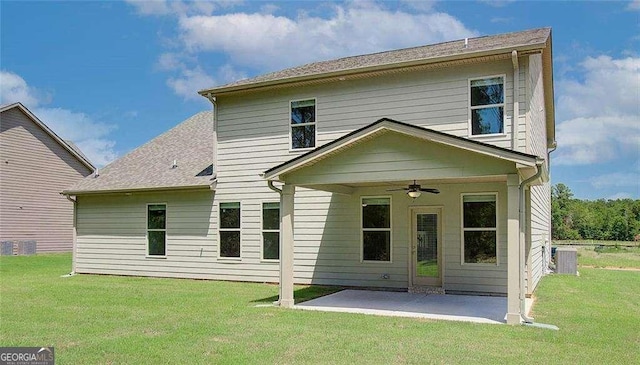 back of property with a lawn, a patio, and ceiling fan