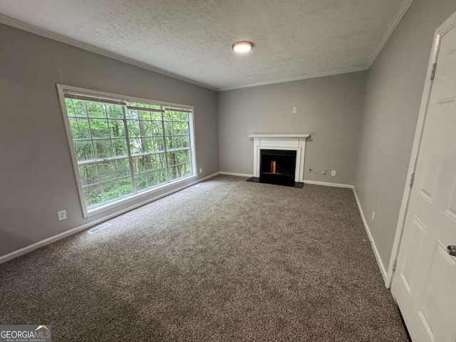 unfurnished living room featuring carpet flooring, crown molding, visible vents, and a fireplace with raised hearth
