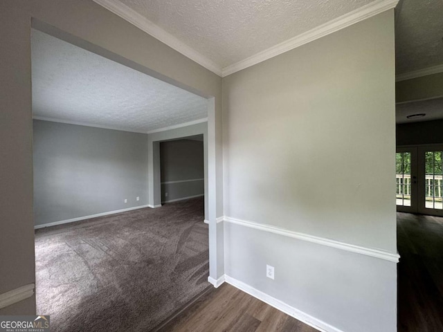 unfurnished room with french doors, wood finished floors, crown molding, a textured ceiling, and baseboards