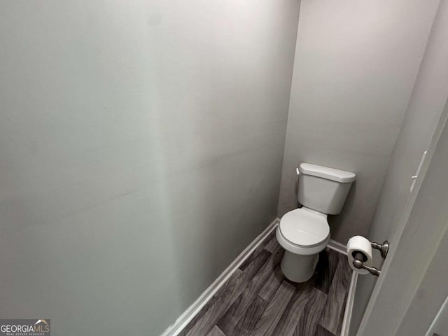 bathroom featuring toilet and wood finished floors