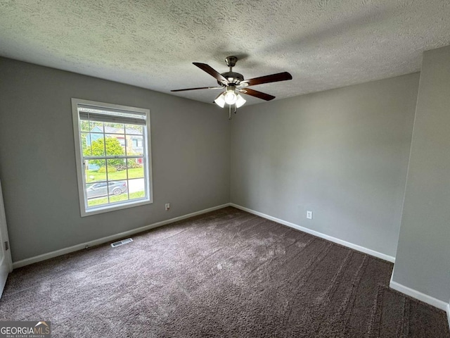 unfurnished room with a ceiling fan, carpet flooring, visible vents, and baseboards
