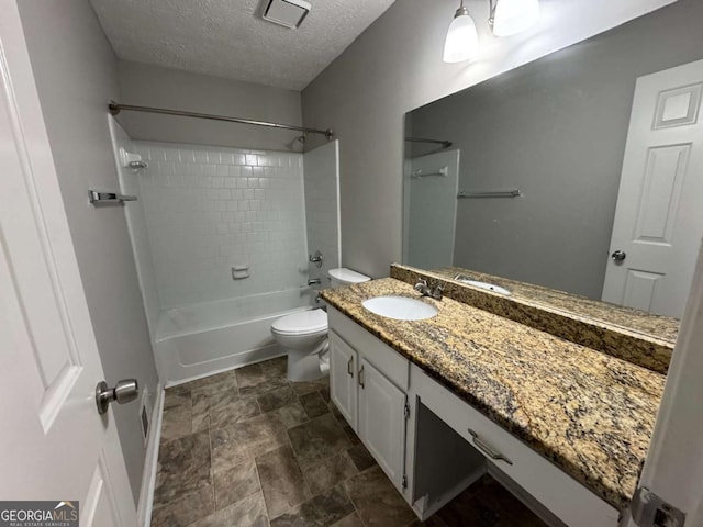 full bath with a textured ceiling, toilet, visible vents, shower / tub combination, and vanity