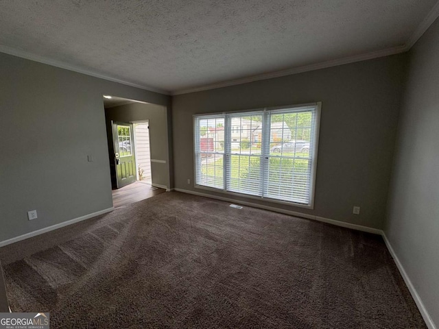 carpeted empty room with crown molding, a textured ceiling, and baseboards