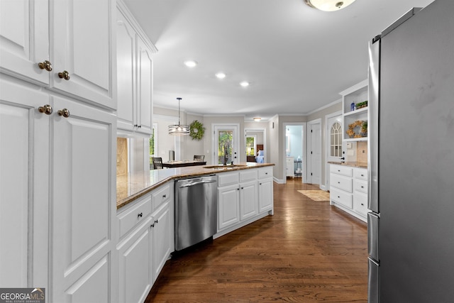 kitchen featuring ornamental molding, stainless steel appliances, white cabinetry, and a peninsula