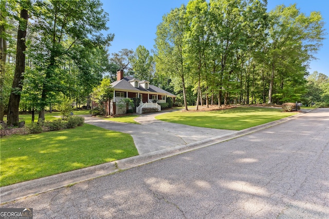 view of front of house with a front lawn and a chimney