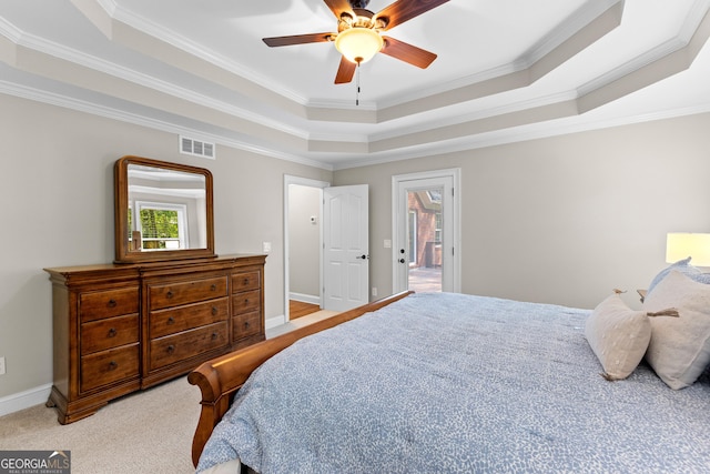 carpeted bedroom with crown molding, visible vents, baseboards, a raised ceiling, and ceiling fan