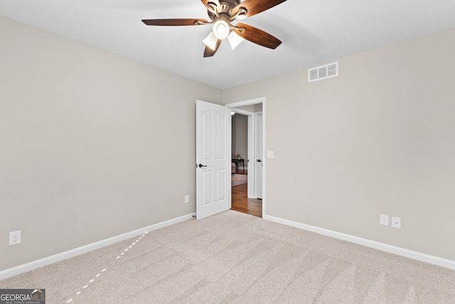 unfurnished bedroom featuring baseboards, ceiling fan, carpet flooring, and visible vents