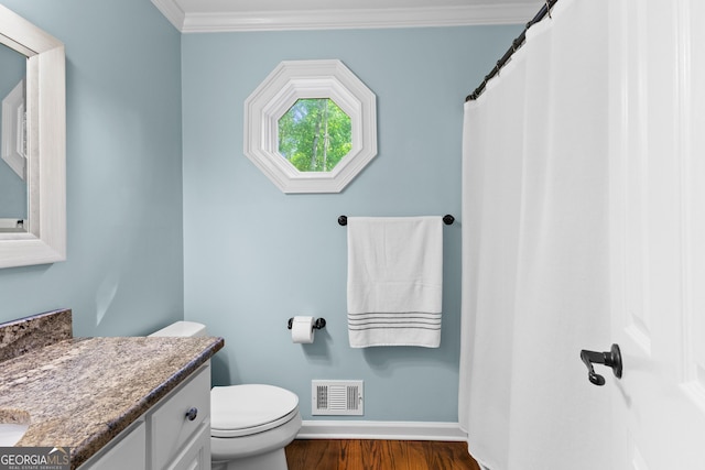 bathroom featuring baseboards, toilet, visible vents, vanity, and wood finished floors