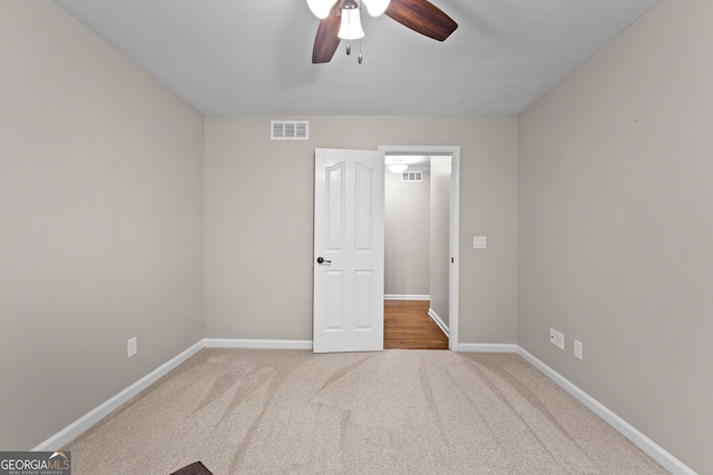 unfurnished bedroom with baseboards, ceiling fan, visible vents, and carpet