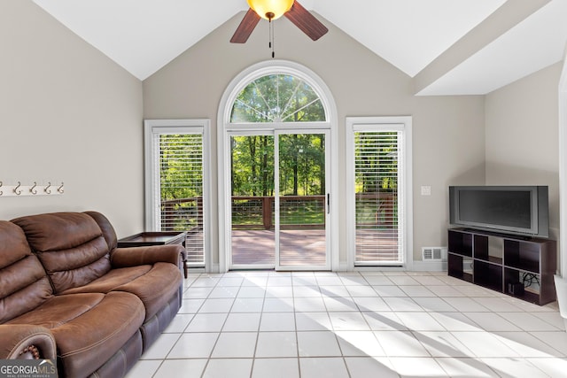 living area with light tile patterned floors, lofted ceiling, a ceiling fan, and visible vents