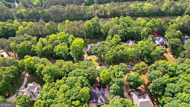 drone / aerial view featuring a forest view