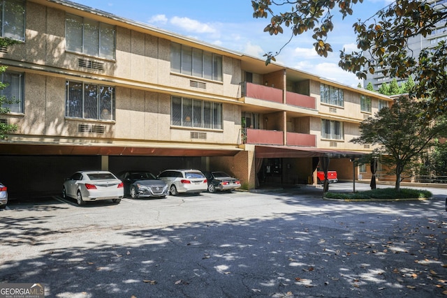 view of building exterior featuring covered parking