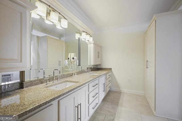 full bath with double vanity, baseboards, and crown molding