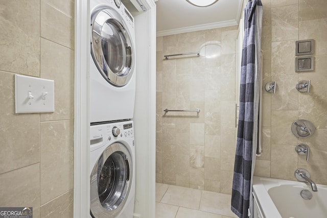 bathroom with stacked washing machine and dryer, crown molding, shower / bath combo, and tile walls