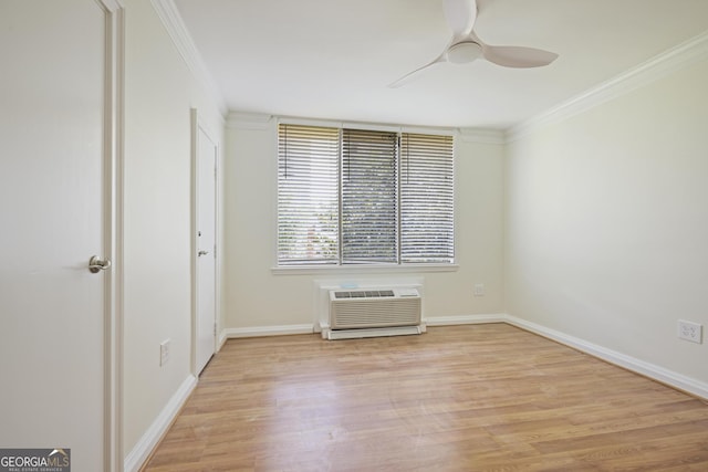 spare room featuring ceiling fan, light wood-style floors, crown molding, baseboards, and a wall unit AC