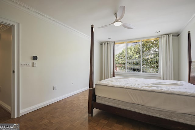 bedroom with crown molding, baseboards, and ceiling fan