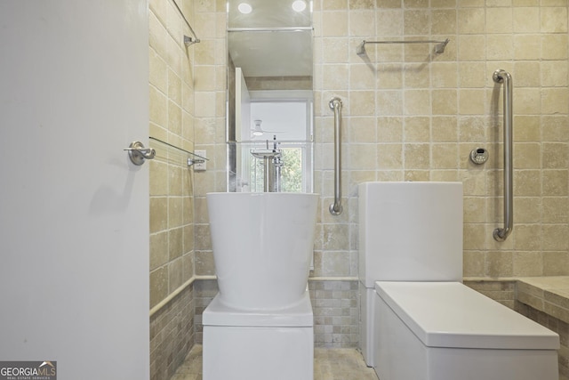 full bathroom featuring tile walls and a tile shower
