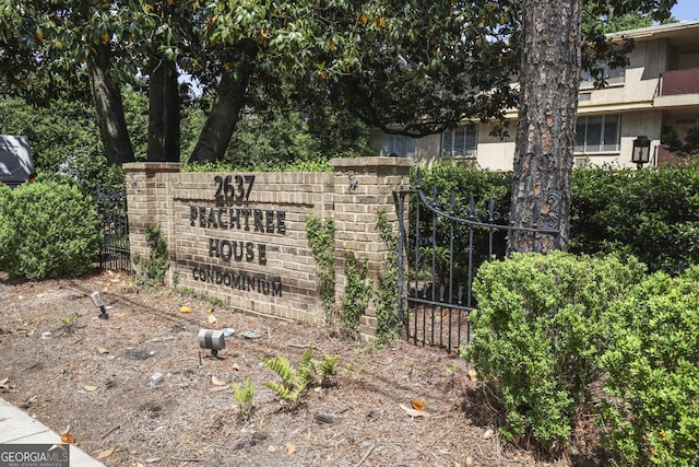community sign with fence and a gate