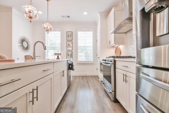 3313 Bartee Walk, Suwanee, GA 30024 - kitchen with wall chimney exhaust hood, appliances with stainless steel finishes, light countertops, a chandelier, and recessed lighting