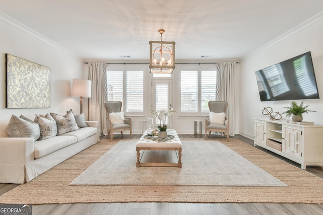 3313 Bartee Walk, Suwanee, GA 30024 - living room featuring crown molding, a notable chandelier, and wood finished floors
