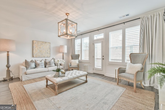 3313 Bartee Walk, Suwanee, GA 30024 - living room featuring a chandelier, wood finished floors, visible vents, and baseboards