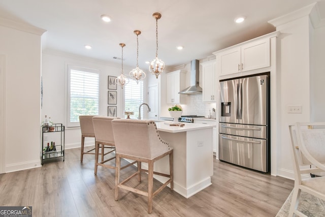 3313 Bartee Walk, Suwanee, GA 30024 - kitchen with stainless steel fridge, wall chimney range hood, a kitchen island with sink, light countertops, and light wood-type flooring