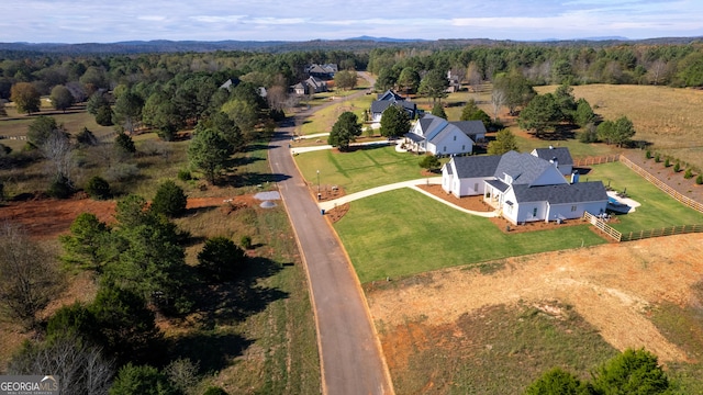 birds eye view of property with a view of trees