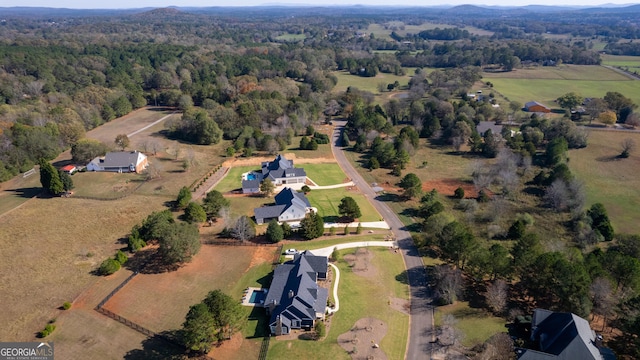 bird's eye view with a rural view and a wooded view