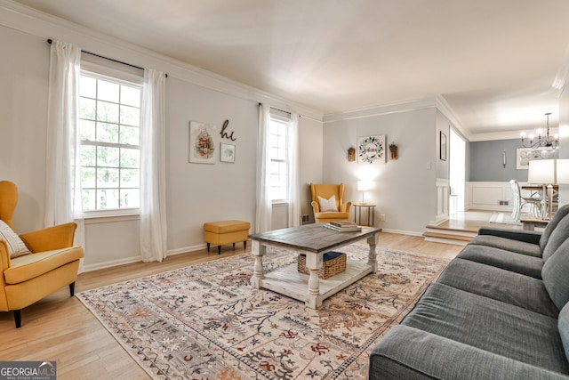 2244 Deer Ridge Dr, Tucker, GA 30087 - living area featuring ornamental molding, a chandelier, light wood finished floors, and wainscoting