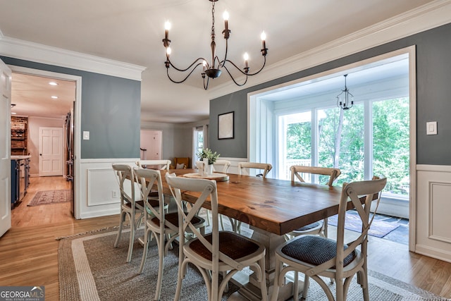 2244 Deer Ridge Dr, Tucker, GA 30087 - dining space with ornamental molding, a chandelier, wainscoting, light wood finished floors, and a decorative wall