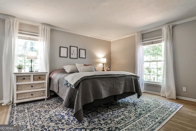 2244 Deer Ridge Dr, Tucker, GA 30087 - bedroom featuring multiple windows, wood finished floors, crown molding, and baseboards