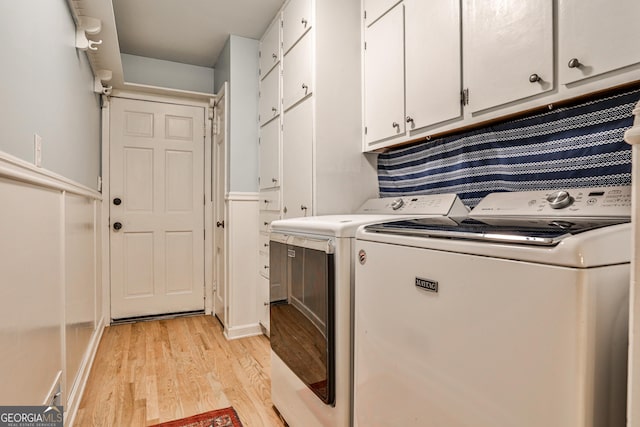 2244 Deer Ridge Dr, Tucker, GA 30087 - washroom with washing machine and clothes dryer, cabinet space, and light wood finished floors