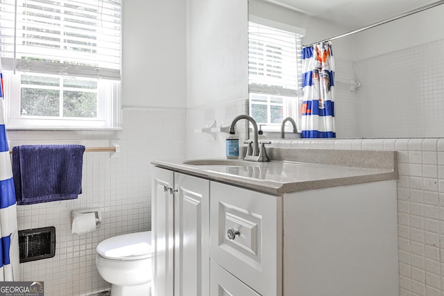 2244 Deer Ridge Dr, Tucker, GA 30087 - bathroom with tile walls, healthy amount of natural light, vanity, toilet, and a shower with shower curtain