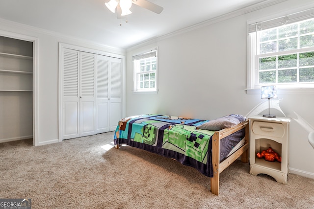 2244 Deer Ridge Dr, Tucker, GA 30087 - carpeted bedroom featuring ornamental molding, multiple windows, baseboards, multiple closets, and a ceiling fan