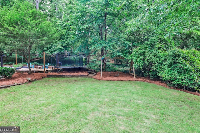 2244 Deer Ridge Dr, Tucker, GA 30087 - view of grassy yard featuring a trampoline