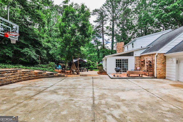 2244 Deer Ridge Dr, Tucker, GA 30087 - view of patio featuring driveway and view of scattered trees