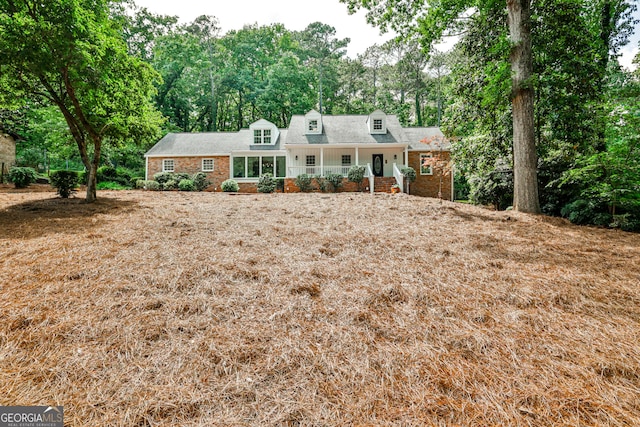 2244 Deer Ridge Dr, Tucker, GA 30087 - view of front facade with a porch, brick siding, and roof with shingles